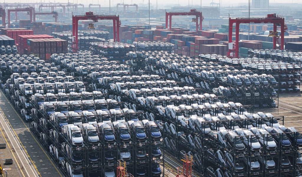 (FILES) BYD electric cars waiting to be loaded onto a ship are seen stacked at the international container terminal of Taicang Port in Suzhou, in China’s eastern Jiangsu province on February 8, 2024. Canada will allow 49,000 Chinese electric vehicles to be imported under new, preferential tariff rates, Prime Minister Mark Carney said on January 16, 2026 after reaching a trade deal with China's leader Xi Jinping in Beijing. (Photo by AFP) / China OUT