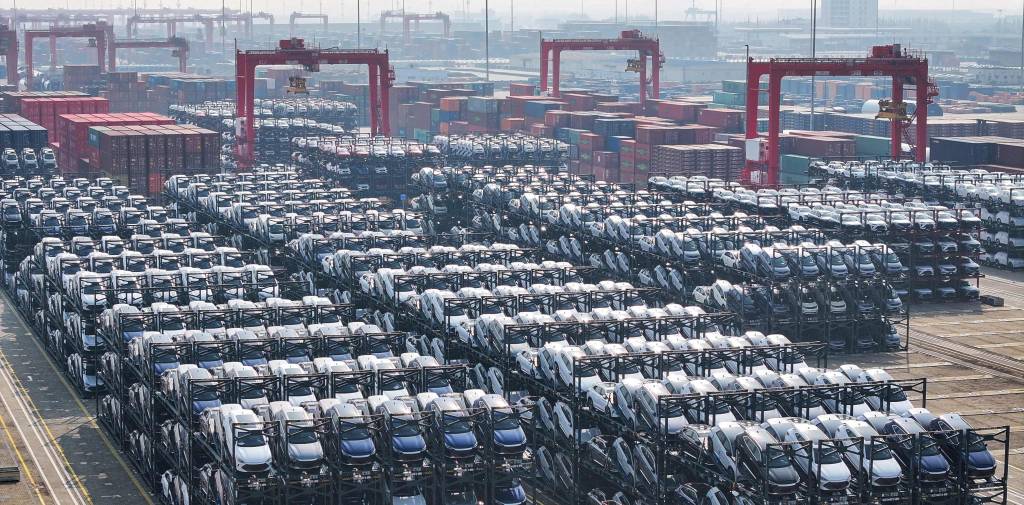 (FILES) BYD electric cars waiting to be loaded onto a ship are seen stacked at the international container terminal of Taicang Port in Suzhou, in China’s eastern Jiangsu province on February 8, 2024. Canada will allow 49,000 Chinese electric vehicles to be imported under new, preferential tariff rates, Prime Minister Mark Carney said on January 16, 2026 after reaching a trade deal with China's leader Xi Jinping in Beijing. (Photo by AFP) / China OUT